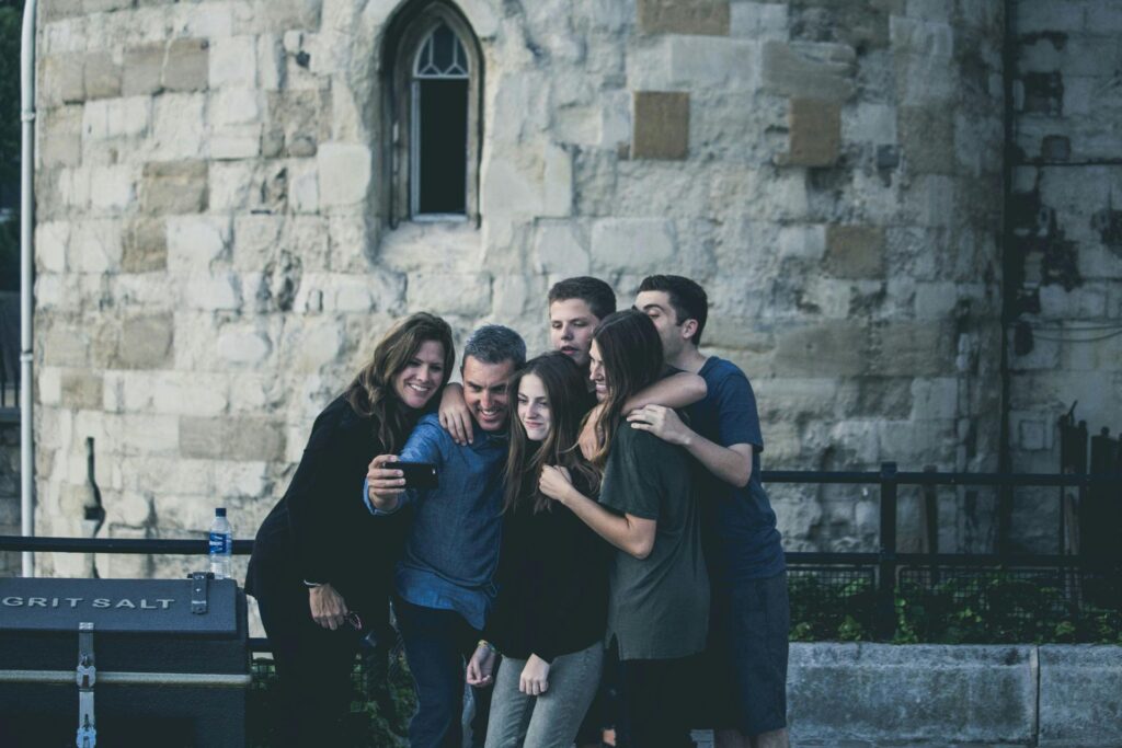 Group of friends enjoying a moment together while taking a selfie outdoors.