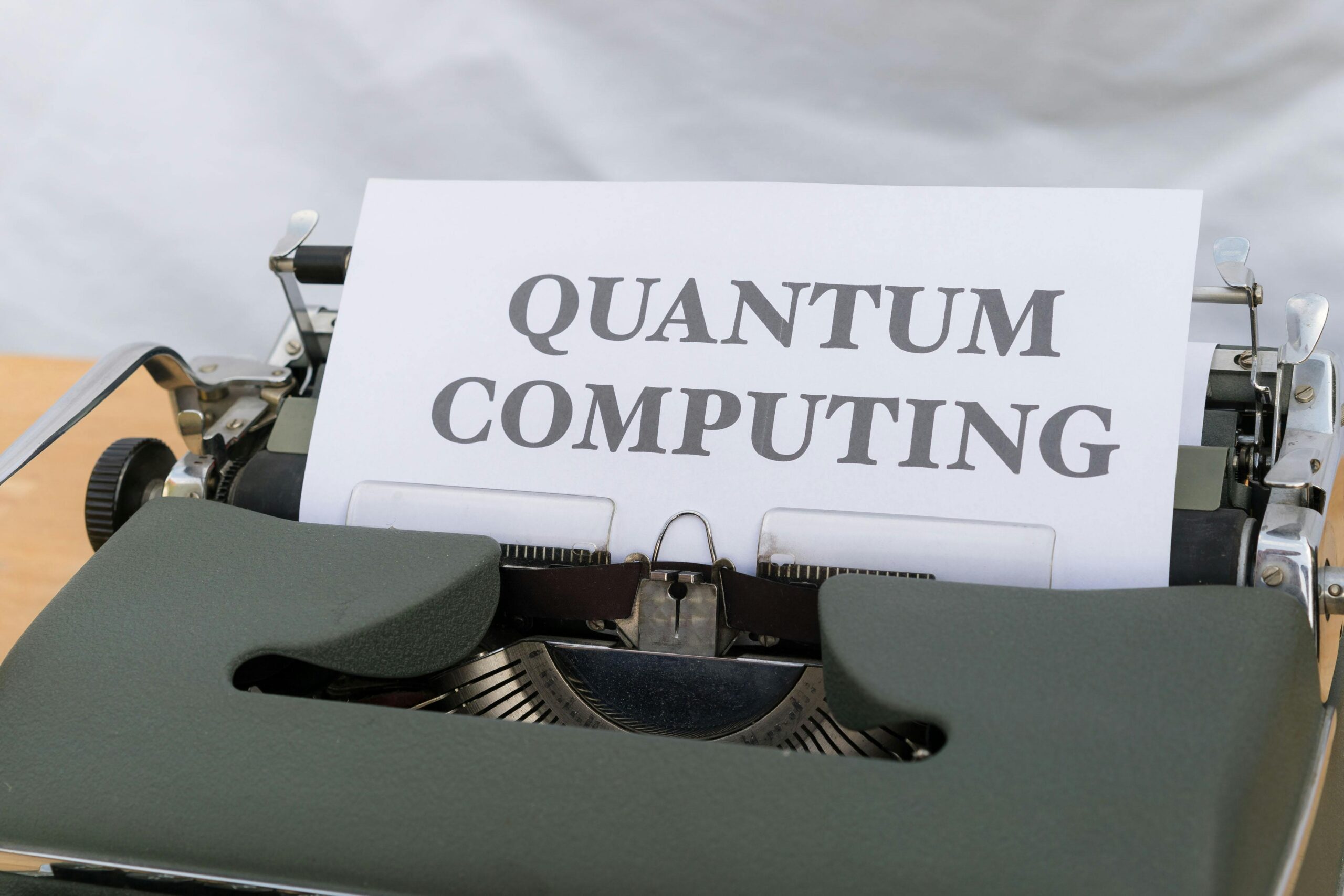 A vintage typewriter with a paper displaying the term Quantum Computing.
