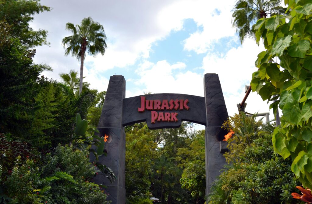 A lush, iconic Jurassic Park entrance in Orlando's Universal Studios.