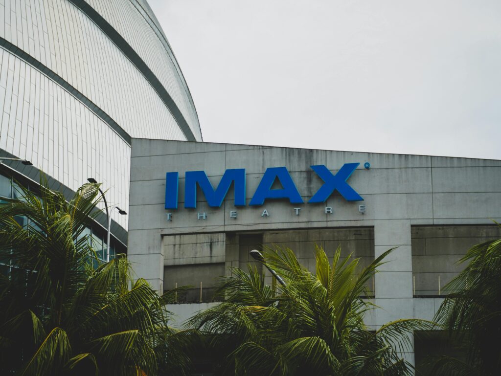 Exterior view of IMAX Theatre in Pasay City, Philippines with palm trees.