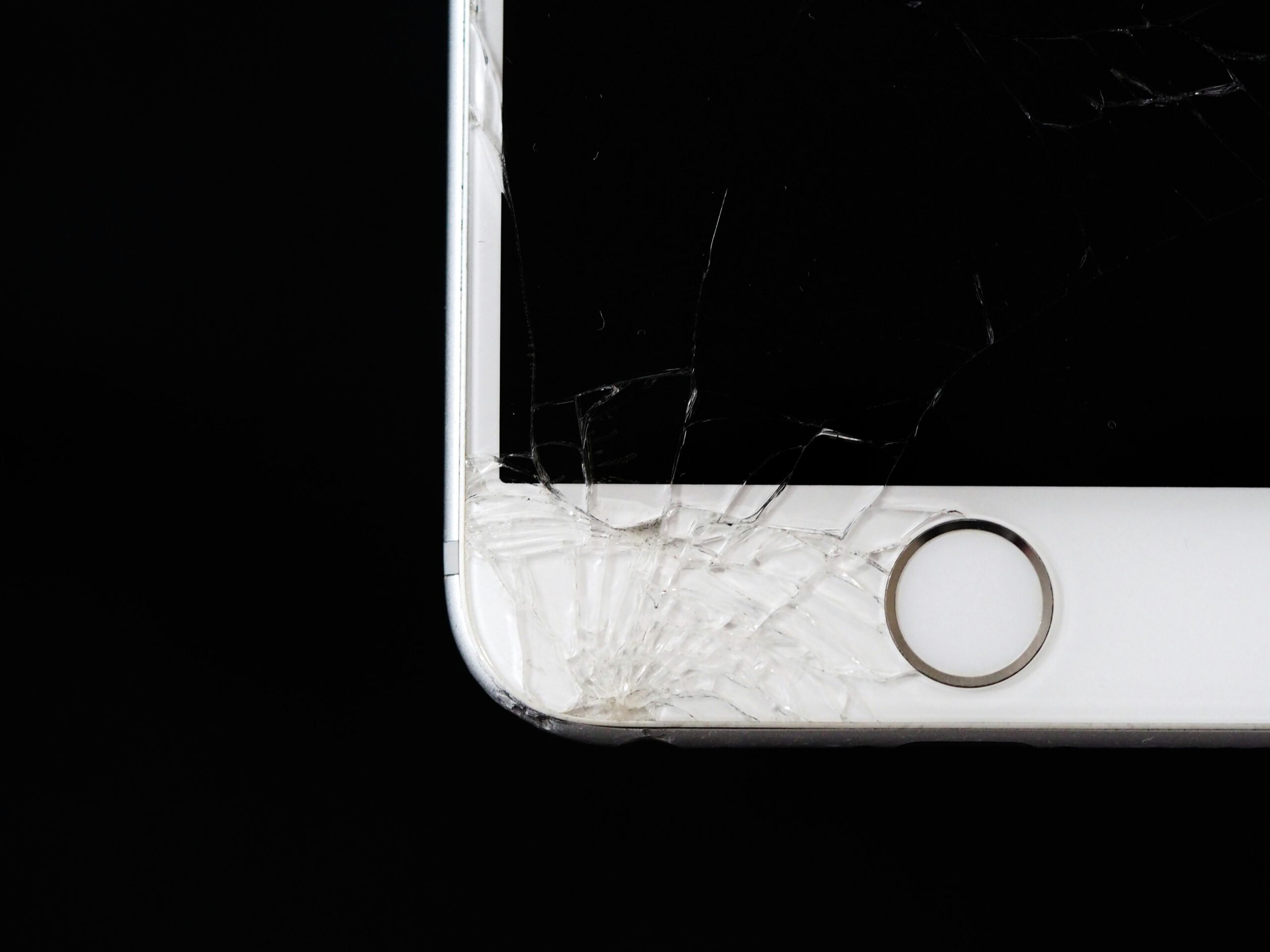 Detailed image of a cracked smartphone screen highlighting damage to the device.