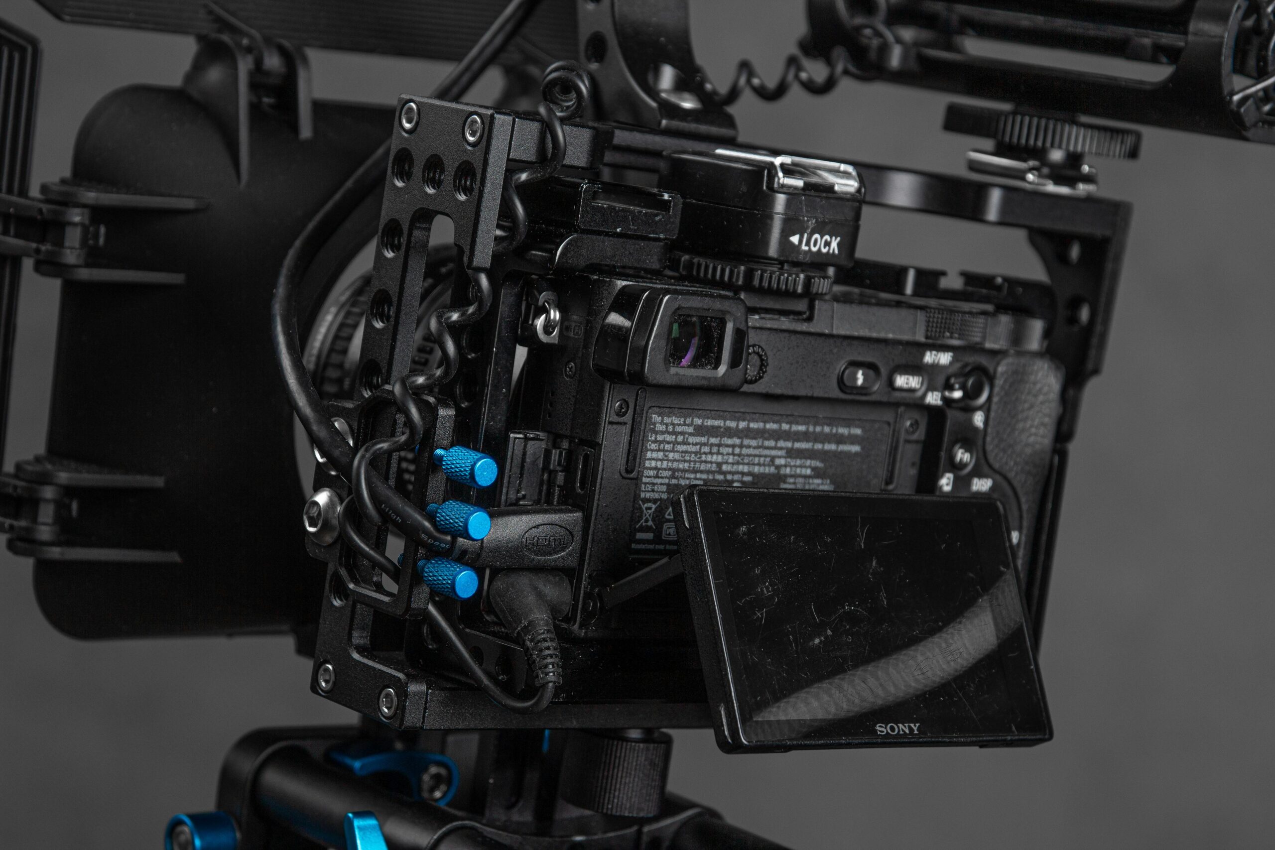 Detailed view of a professional video camera with rig and cables.